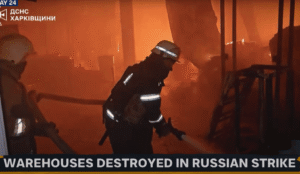 a firefighter in a room with a fire hose
